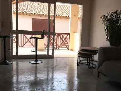 a living room with a couch and a table and chairs at Island Retreat in Santa Maria