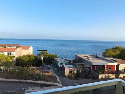 a view of the ocean from a balcony at Old Town view Apartment in Cidade Velha