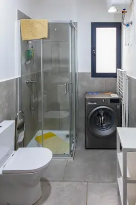 a bathroom with a washing machine and a washer at Ocean View Luxury in Santa Maria