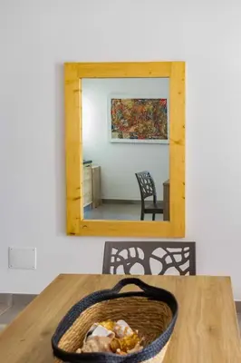 a mirror on a wall above a table with a basket at Ocean View Luxury in Santa Maria