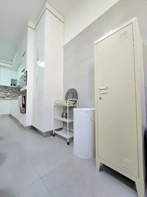 a kitchen with white walls and a white refrigerator at Casa Bela in Mindelo