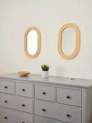 two mirrors above a dresser in a room at Casa Bela in Mindelo