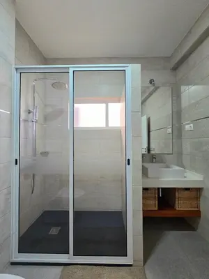a bathroom with a glass shower and a sink at Casa Bela in Mindelo