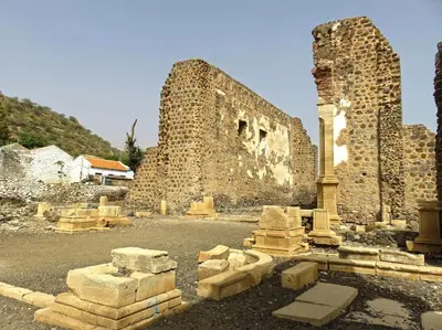 an old stone building with a tower and some rubble at Catedral View Apartment in Cidade Velha