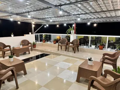 a lobby with chairs and tables in a building at Catedral View Apartment in Cidade Velha