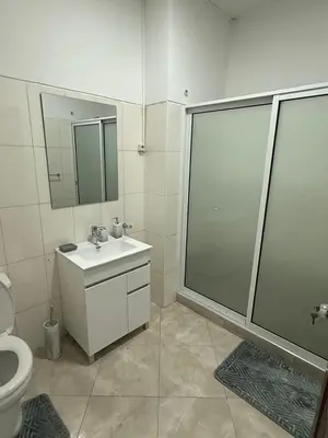 a bathroom with a shower and a sink and a toilet at Casa Cucuia in Praia
