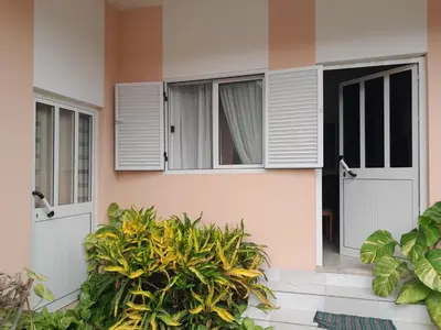 a house with white doors and windows and plants at NoS Casa in Montanha