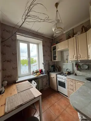 a kitchen with a table and a window in it at Apt Martins May 2 in Vila do Maio