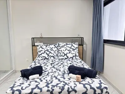 a bedroom with a bed with two pillows on it at Relax and Stay in Praia Spacious 3bdr Apartment in Praia