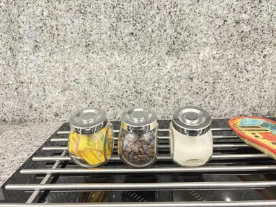 a counter with three jars of food on a shelf at Relax and Stay in Praia Spacious 3bdr Apartment in Praia