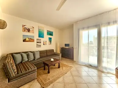 a living room with a couch and a table at Salty Soul Ac Wifi in Santa Maria
