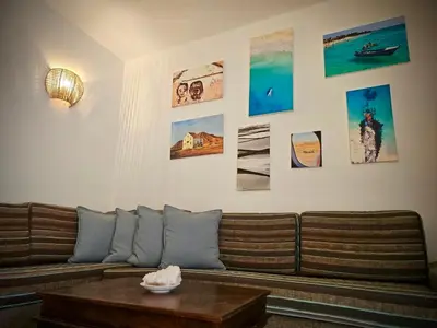 a living room with a couch and pictures on the wall at Salty Soul Ac Wifi in Santa Maria