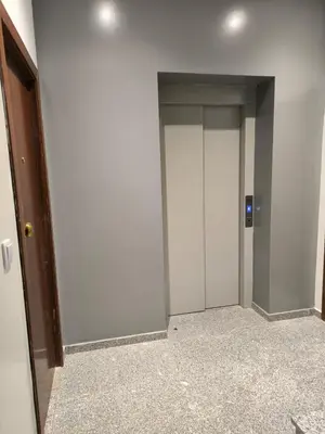 a hallway with two elevators in a building at Apartamento Praia JOIA in Praia