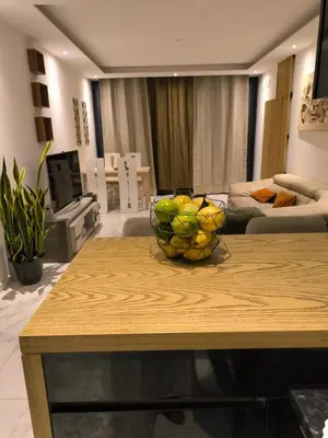 a living room with a bowl of fruit on a table at Apartamento Praia JOIA in Praia