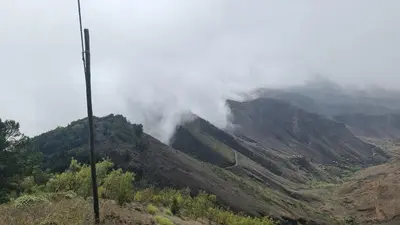 a mountain with clouds on top of it at Dolphin Cabo Verde in Tarrafal