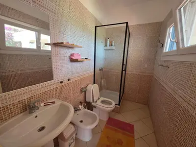 a bathroom with a sink and a toilet and a shower at Dolphin Cabo Verde in Tarrafal