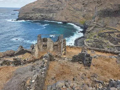 an old castle on a cliff next to the ocean at Dolphin Cabo Verde in Tarrafal