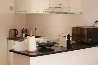 a kitchen with a counter with a microwave and a stove at Casa Ida 2 Tarrafal, Santiago, Cape verde in Tarrafal
