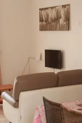 a living room with a couch and a flat screen tv at Casa Ida 2 Tarrafal, Santiago, Cape verde in Tarrafal