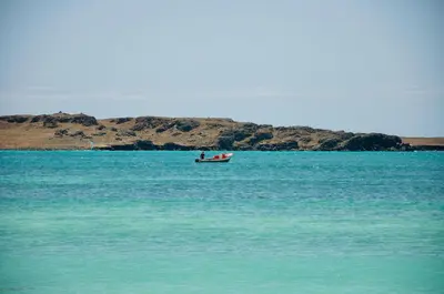 a boat in the middle of a large body of water at Beautiful Penthouse in Sal Rei