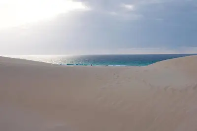 a sand dune with the ocean in the background at Beautiful Penthouse in Sal Rei