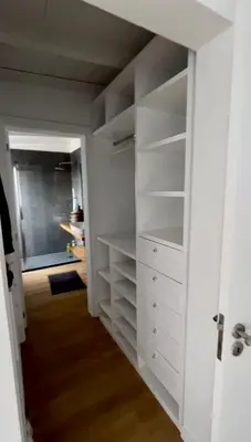 a white closet with white shelves and a hallway at Beautiful Penthouse in Sal Rei