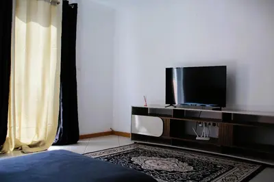 a bedroom with a tv and a bed in a room at PR T1 TerceiroB in Praia