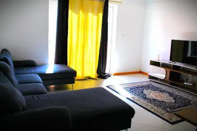 a living room with a couch and a tv at PR T1 TerceiroB in Praia