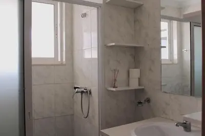 a bathroom with a shower and a sink at PR T1 TerceiroB in Praia
