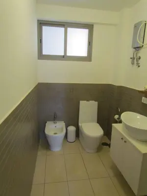 a bathroom with a toilet and a sink at Apartamento T1 - Hotel Las Rochas in Mindelo
