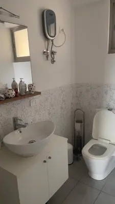 a bathroom with a sink and a toilet at Apartamento T1 - Hotel Las Rochas in Mindelo