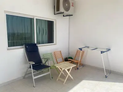 a room with chairs and a table and a window at Casa Ramanda in Tarrafal