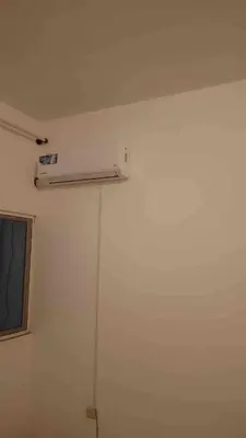 a room with a white wall with a air conditioner at Casa Ramanda in Tarrafal