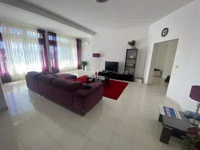 a living room with a couch and a tv at Casa Ramanda in Tarrafal
