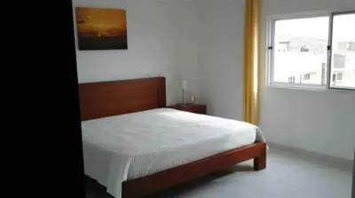 a bedroom with a bed and a window at Casa Ramanda in Tarrafal