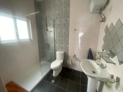 a bathroom with a toilet and a sink and a shower at Casa Ramanda in Tarrafal