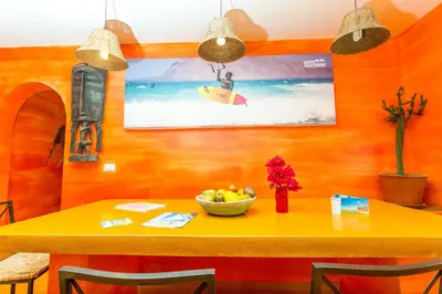 a dining room table with a bowl of fruit on it at Surfactivity Guest House in Santa Maria