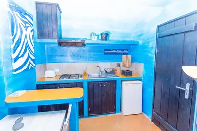 a blue kitchen with a sink and a counter at Surfactivity Guest House in Santa Maria