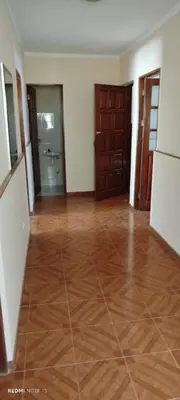 an empty room with a wooden floor and doors at Residencial Soares in Espargos