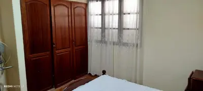 a bedroom with a wooden cabinet and a window at Residencial Soares in Espargos