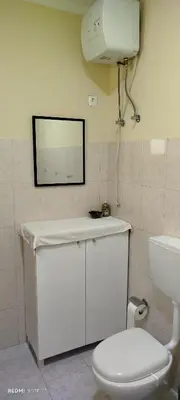a bathroom with a white toilet and a mirror at Residencial Soares in Espargos