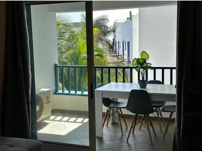 a balcony with a table and chairs on a balcony at Leme Bedje Residence in Santa Maria