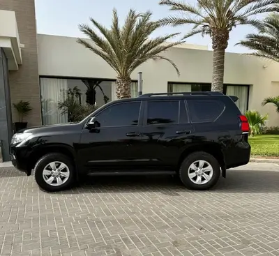 a black suv parked in a parking lot with palm trees at Aaparthotel Book a Taxi Group in Prainha