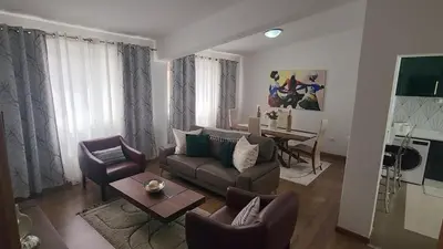 a living room with a couch and chairs and a table at Our Happy Place Prainha in Praia