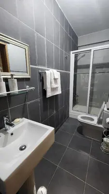 a bathroom with a white sink and a toilet at Our Happy Place Prainha in Praia
