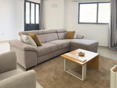 a living room with a couch and a coffee table at Spacious 2 bdr apt in Achada St Antonio - LCGR in Praia