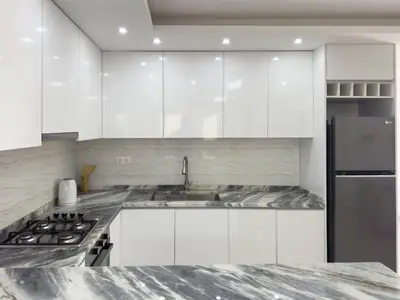 a white kitchen with a sink and a refrigerator at Spacious 2 bdr apt in Achada St Antonio - LCGR in Praia