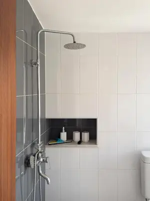 a bathroom with a shower with a glass door at Spacious 2 bdr apt in Achada St Antonio - LCGR in Praia