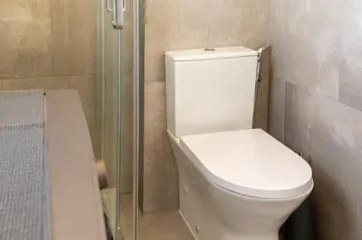 a bathroom with a white toilet and a shower at Atlantic Sal Ocean View in Santa Maria