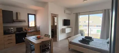 a kitchen and living room with a table and a dining room at Atlantic Sal Ocean View in Santa Maria